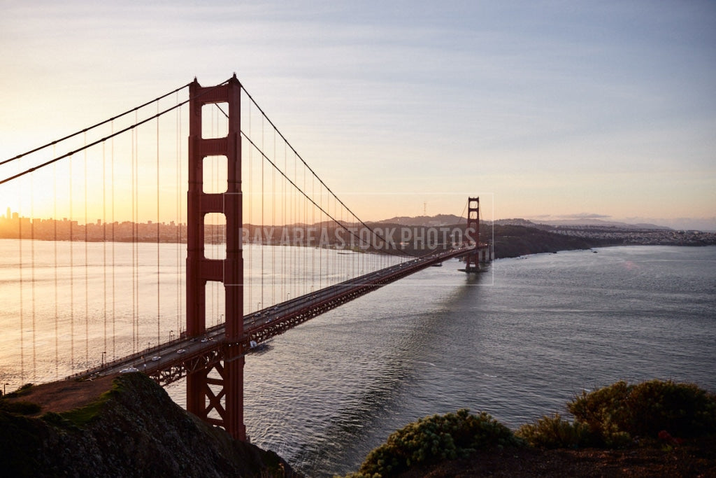 Commuting Traffic Crossing Golden Gate Bridge At Sunrise